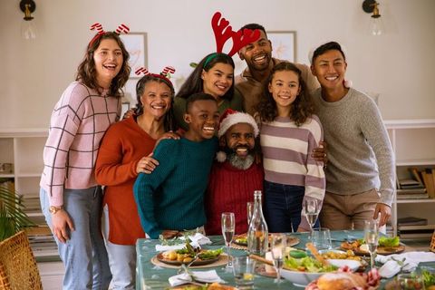 Diverse Family Celebrating Holiday Meal with Festive Decorations
