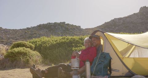 Elderly Couple Enjoying Camping Retreat in Mountains