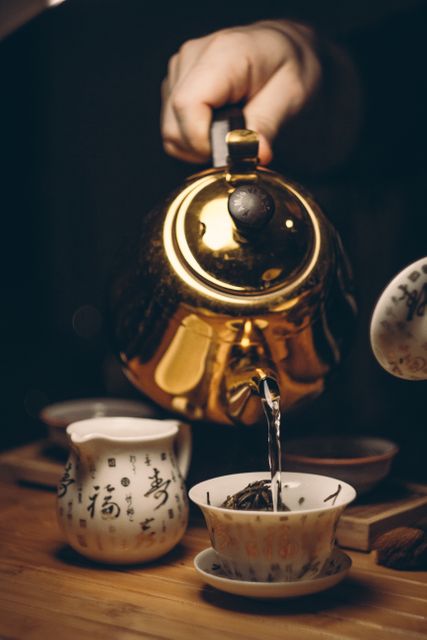 Traditional Chinese Tea Ceremony with Golden Teapot - Download Free Stock Photos Pikwizard.com