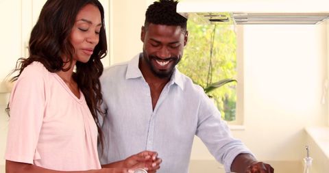 Joyful Couple Bonding in Kitchen with Smiles