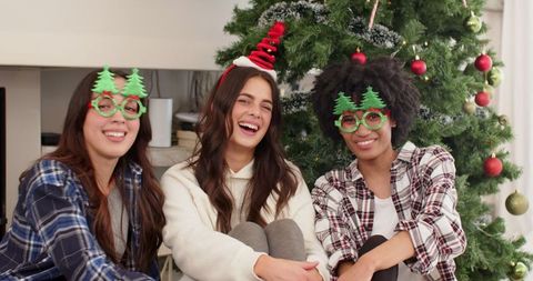 Diverse Friends Enjoying Christmas Festivities with Novelty Glasses