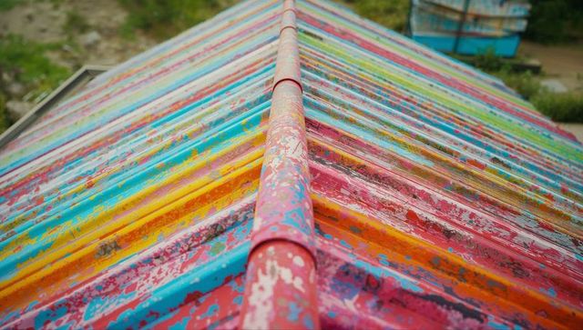 Vibrant Weathered Striped Roof in Boatyard Scene