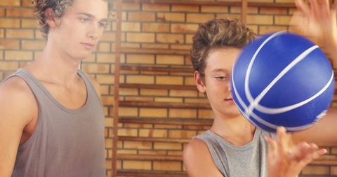 Teens Practicing Basketball Tricks with Blue Basketball - Download Free Stock Images Pikwizard.com