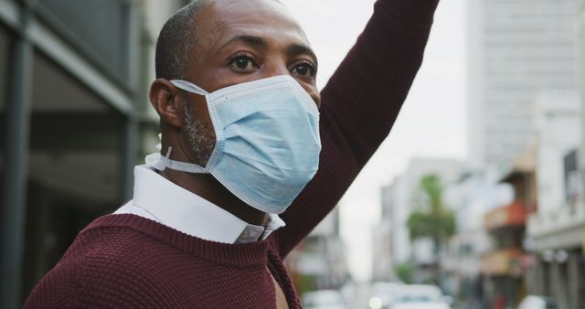 Portrait of man wearing face mask on city street - Download Free Stock Images Pikwizard.com