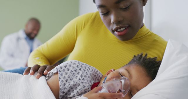 African american mother with patient son in oxygen mask, lying in bed at hospital - Download Free Stock Photos Pikwizard.com