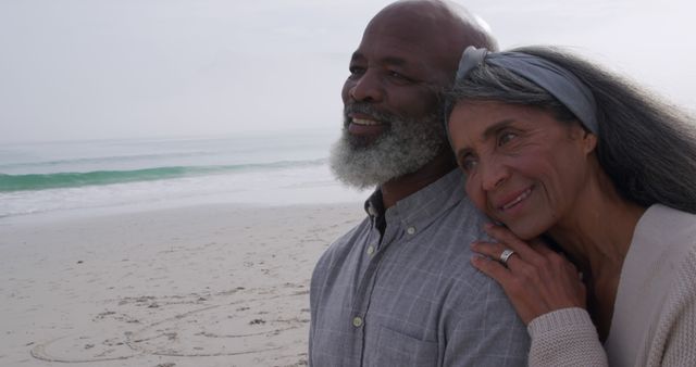 Happy senior couple embracing on a serene beach - Download Free Stock Images Pikwizard.com