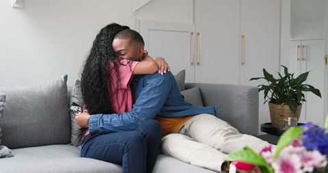 Couple Celebrating Pregnancy with Joyful Embrace at Home