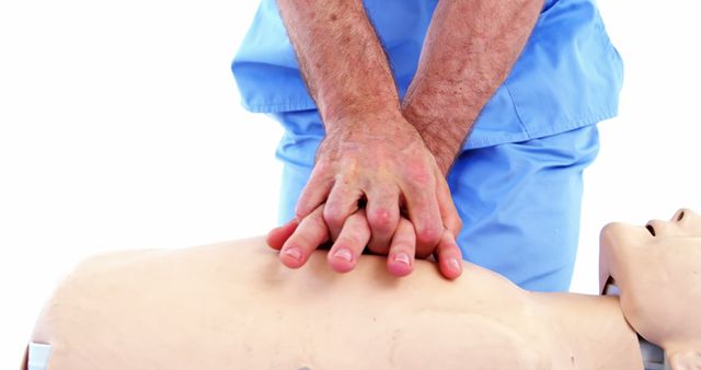 A healthcare professional is performing CPR on a training mannequin, demonstrating the proper technique for chest compressions, with copy space. Such training is crucial for emergency response and saving lives in critical situations.