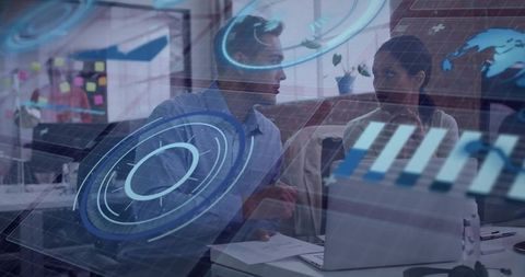 Two Colleagues Collaborating Over Laptop with Augmented Data HUD and Business Analytics