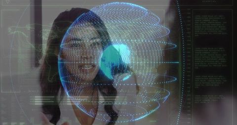 Businesswoman interacting with holographic globe in futuristic office