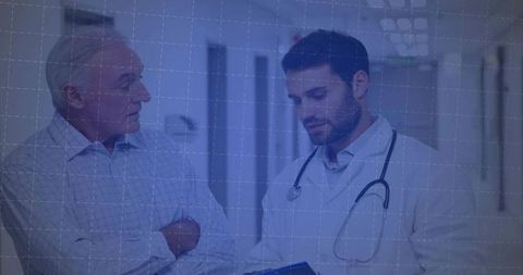 Doctor Discussing Medical Notes with Patient in Hospital Corridor