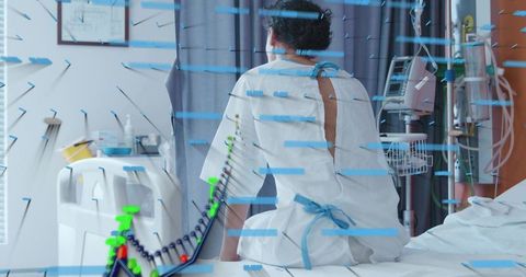 Sitting patient wearing gown monitoring iv infusion and vital signs in clinical care