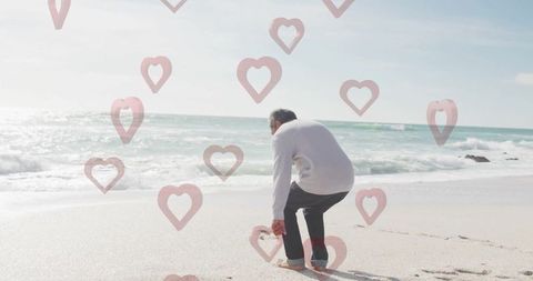 Senior man enjoying peaceful beach day with heart overlay