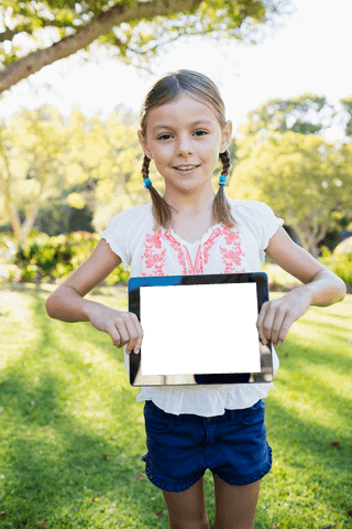 smiling girl holding digital tablet outdoors in transparent park - Download Free Stock Videos Pikwizard.com