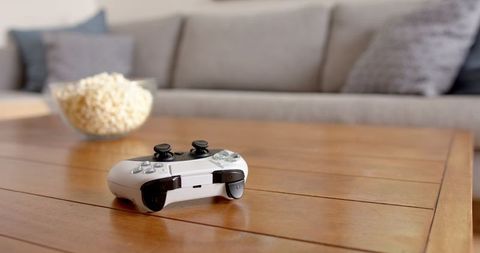 modern minimalist gaming setup with game controller and popcorn - Download Free Stock Images Pikwizard.com
