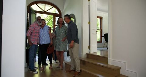 Diverse Senior Friends Gather for Wine and Celebration