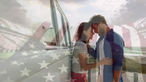Couple Embracing Beachside Against Overlay of USA Flag