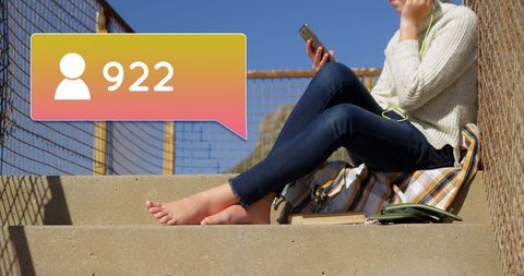 Young Woman Enjoying Music and Selfies on Sunlit Stairway