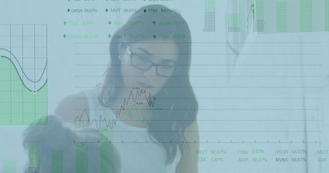 Focused businesswoman studying data charts in office setting