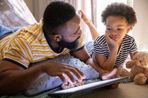 Father and Daughter Bonding with Tablet in Cozy Home Setting