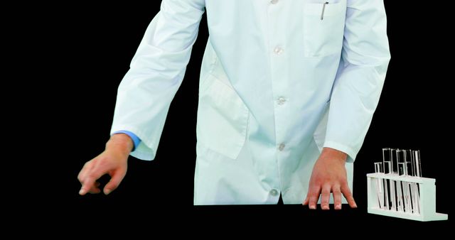 Scientist in lab coat preparing test tubes for an experiment in a laboratory setting. Perfect for use in medical and scientific content, educational materials, and research presentations.