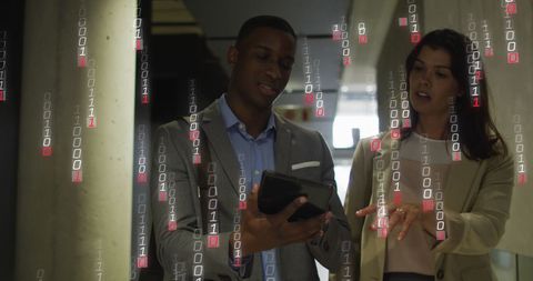 Business Professionals Using Tablet with Binary Code Overlay