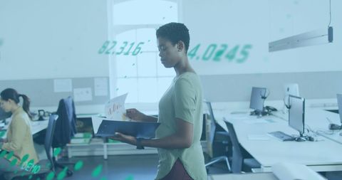 Focused Businesswoman Analyzing Graphs in Modern Office