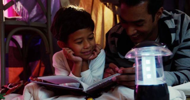 Father and Son Enjoying Bedtime Stories Inside Cozy Fort - Download Free Stock Images Pikwizard.com