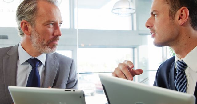 Businessmen Discussing Strategy in Modern Office with Digital Tablets - Download Free Stock Images Pikwizard.com