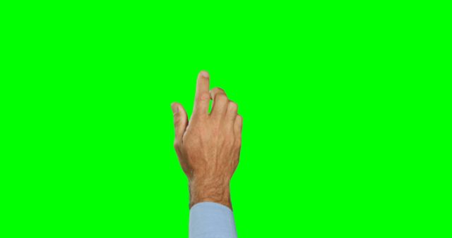 Image shows a close-up of a hand with an extended finger pointing or tapping on a green screen background. Useful for illustrating touchscreen interactions, gesture-based technology, virtual interfaces, digital actions, or technology tutorials. The green screen background makes it easy to customize or overlay with other visuals.