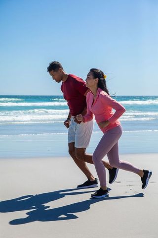 Couple Running on Beach for Fitness and Wellness