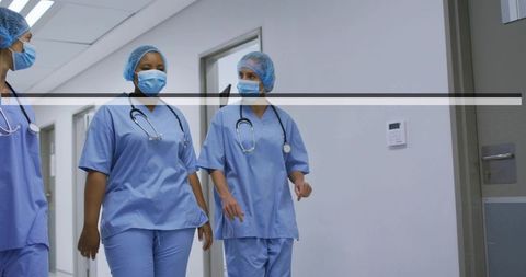 Hospital medical staff walking in corridor collaborating teamwork