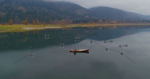 Lone Kayaker Admires Tranquil Lake with Digital Measurement Display