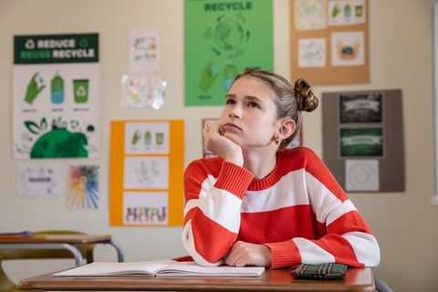 Female child gazing at recycling chart in classroom