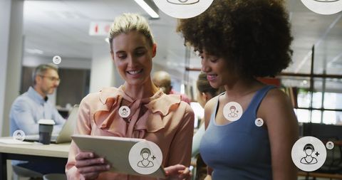 Diverse Colleagues Collaborating on Digital Tablet with Online Data Icons