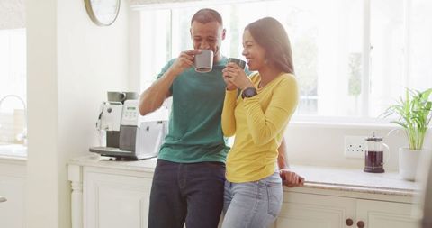 Happy Couple Enjoying Coffee in Bright Kitchen Setting