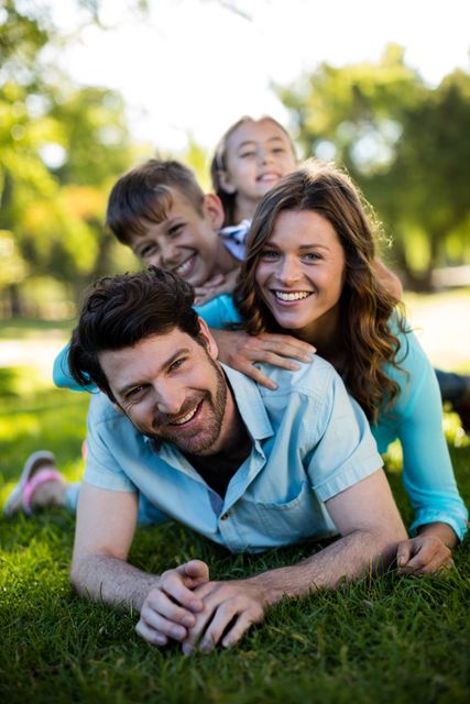 Portrait of happy family playing in park on a sunny day