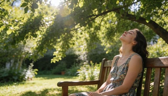 Woman resting on wooden bench under sunlit tree in tranquil garden enjoying summer calm