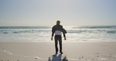 Businessman Embracing Freedom at the Oceanfront
