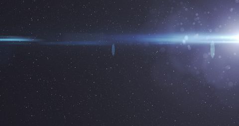 Glowing Blue Star Light in Motion Over Starlit Night Sky