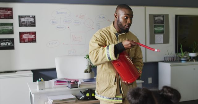 Firefighter conducting a safety demonstration in a school classroom, promoting fire safety awareness among students. Useful for educational campaigns, community safety promotion, and emergency preparedness training.