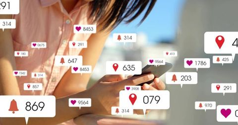 Leaning woman tapping smartphone with floating social notification badges on rooftop balcony