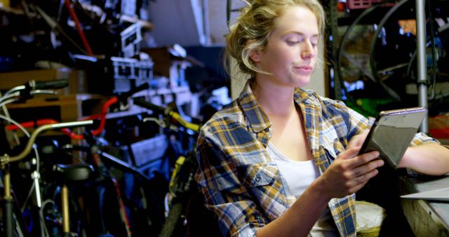 Female Entrepreneur Managing Inventory in Bicycle Shop - Download Free Stock Images Pikwizard.com