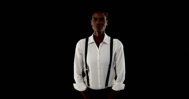 Confident Young Woman in White Shirt with Suspenders Against Black Background - Download Free Stock Images Pikwizard.com