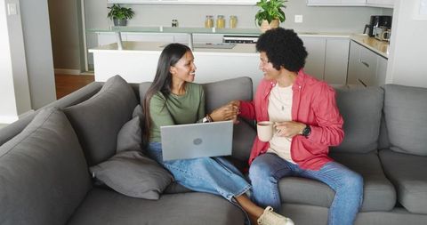 Diverse Couple Exchanging Fist Bump While Relaxing at Home