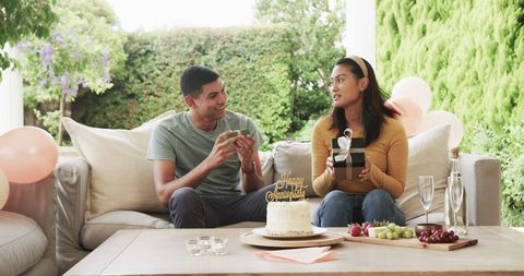 Couple Celebrating Anniversary with Cake and Gifts