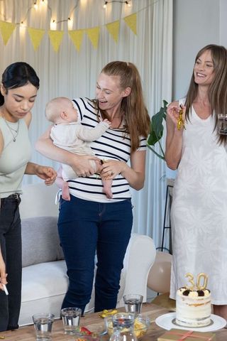 Happy Mothers Gathering Celebrating Friendship with Cake