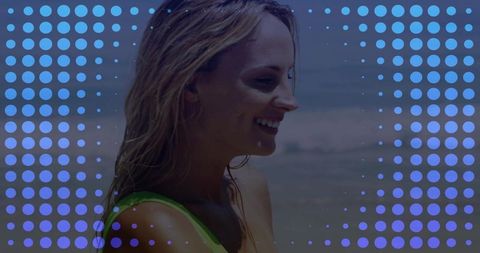 Smiling woman enjoying sunny seaside wearing green swimsuit with blue halftone dot overlay