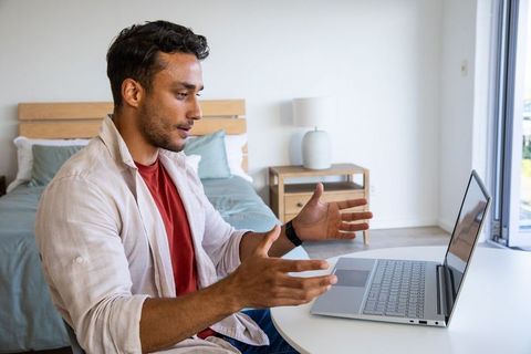 Young Professional Video Conferencing from Stylish Home Office