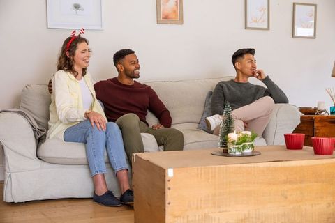 Friends Relax on Sofa During Festive Home Gathering